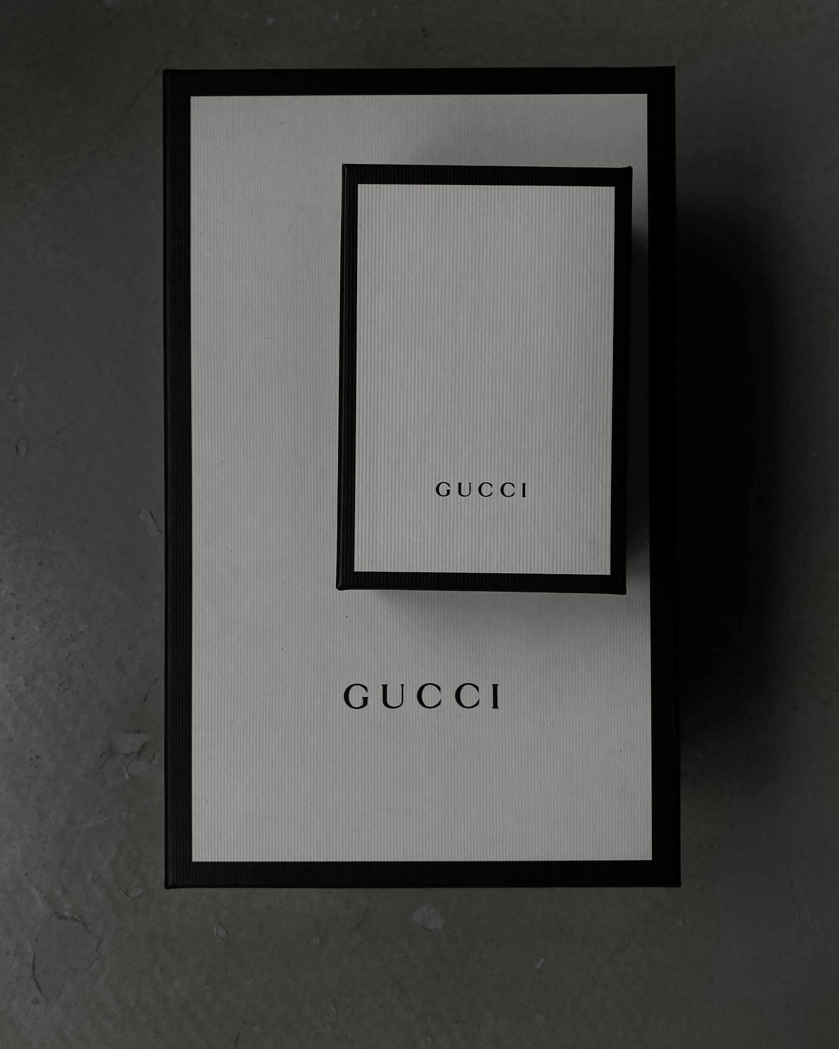 Minimalistic top view of Gucci boxes, perfect for luxury product presentations.